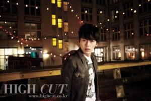 Young man on rooftop with string lights