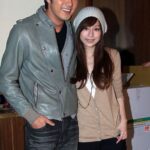 Two people smiling and posing indoors
