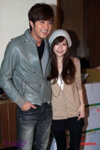 Two people smiling and posing indoors