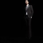 Man in black tuxedo, hands in pockets
