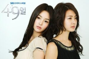 Two women posed back-to-back, gazing away