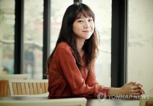 Smiling woman sitting at window table