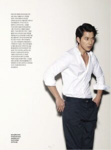 Man posing in white shirt and trousers