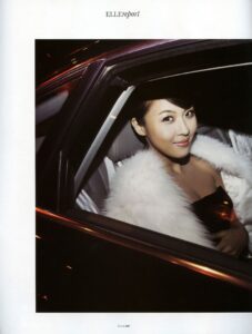 Glamorous woman in white fur coat in car