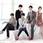 Five young adults posing in stylish outfits