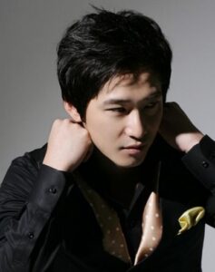 Person adjusting collar in studio portrait