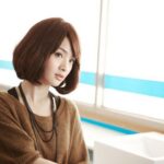 Woman with bob haircut standing by sink