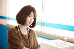 Woman with bob haircut standing by sink