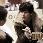 Man in shearling jacket gesturing to woman