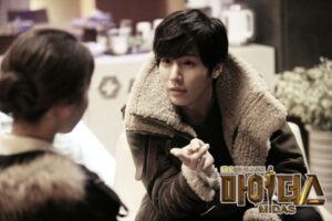 Man in shearling jacket gesturing to woman