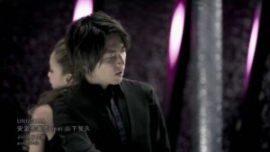 Man and woman in purple-lit studio