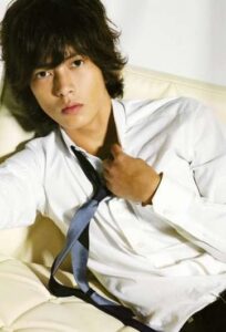 Young man in white shirt adjusting tie