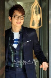 Smiling young man wearing glasses and blazer