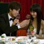 Couple toasting with wine at formal dinner