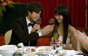 Couple toasting with wine at formal dinner