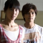 Young man and woman standing indoors