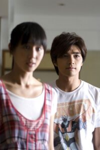 Young man and woman standing indoors