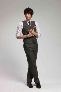 Man in gray vest and tie