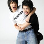 Two young friends hugging and laughing