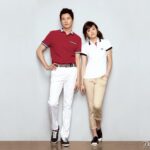 Man and woman in polos against white background