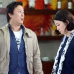 Man talking to upset woman in cafe