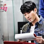 Man reading script in studded denim jacket
