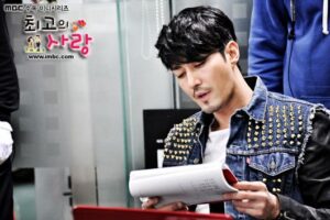 Man reading script in studded denim jacket