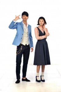 Man making finger-gun gesture beside thoughtful woman