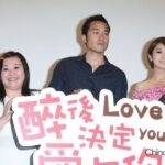 Three smiling people holding "Love you" sign