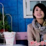 Smiling woman in scarf at cafe table