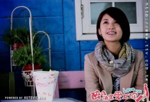 Smiling woman in scarf at cafe table