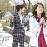 Woman clasping hands in park, man celebrating behind