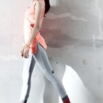 Woman walking in pink athletic top and leggings