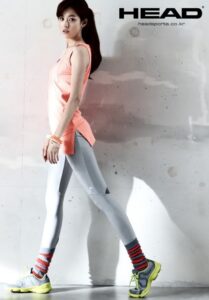Woman walking in pink athletic top and leggings
