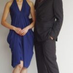 Stylish couple posing by designer logo