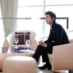 Man in suit seated in modern lounge