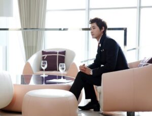 Man in suit seated in modern lounge