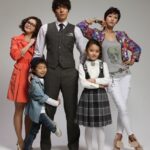 Stylish family of five posing in studio