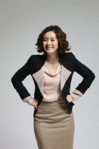 Smiling businesswoman with hands on hips