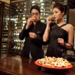 Elegant couple wine tasting in cellar
