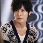 Portrait of young man in patterned cardigan