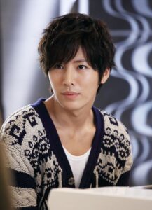 Portrait of young man in patterned cardigan