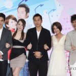 Five people posing together at promotional event