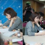 Woman studying in classroom taking notes