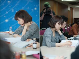 Woman studying in classroom taking notes