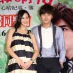 Two people posing at promotional poster
