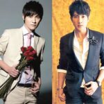Two men in suits posing with roses