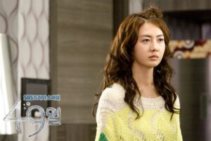 Young woman with wavy hair wearing sweater
