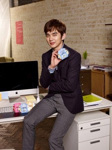 Young man posing in office with products.