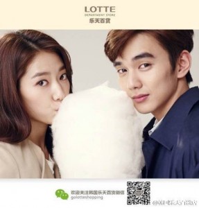 Couple enjoying cotton candy together, smiling.